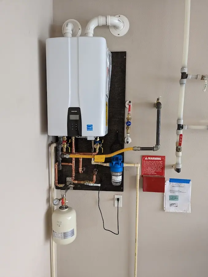 Professional plumber installing copper piping in a East Flat Rock home